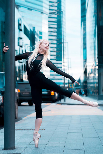 Ballet dancer on the city street. Ballerina. - 写真・画像