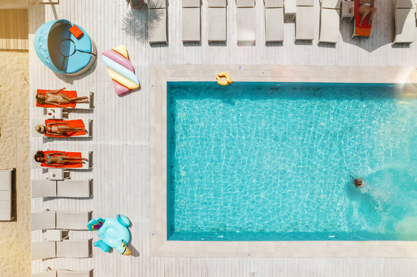 Drone view of people who relaxing in a swimming pool from - Photo, Image
