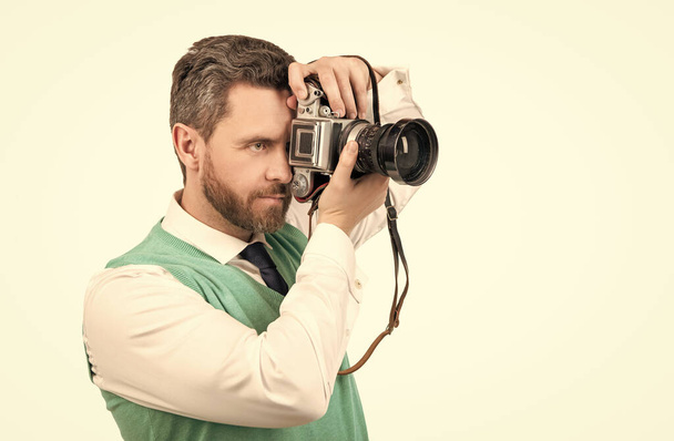 guy taking camera with retro camera isolated on white backdrop, copy space, photographing - Photo, Image