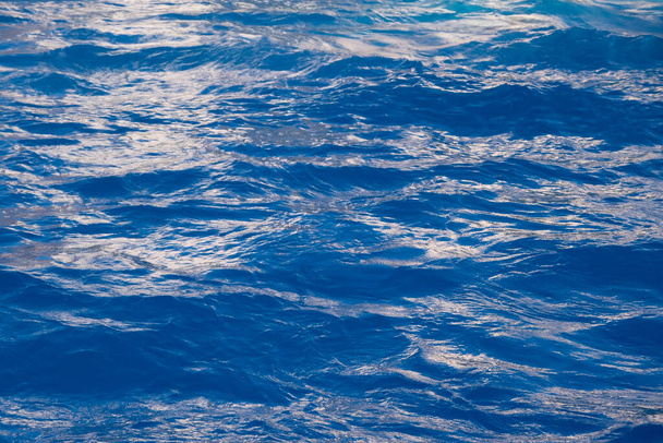 Vivid, bright ripple sea surface. Aqua blue color water texture - Foto, imagen