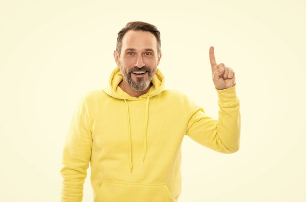 handsome mature man with moustache in hoody pointing finger up isolated on white, announcer. - Photo, Image