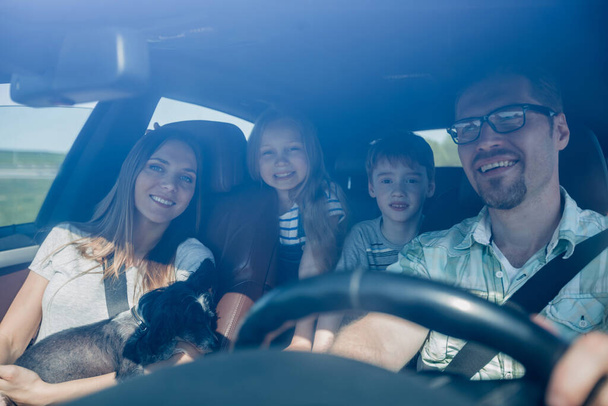 family with two children traveling in a family car - 写真・画像