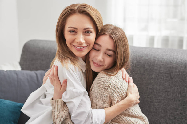Mother and daughter hugging at home - Φωτογραφία, εικόνα