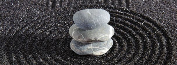 Japanese ZEN garden with yin yang stone in textured sand - Фото, изображение