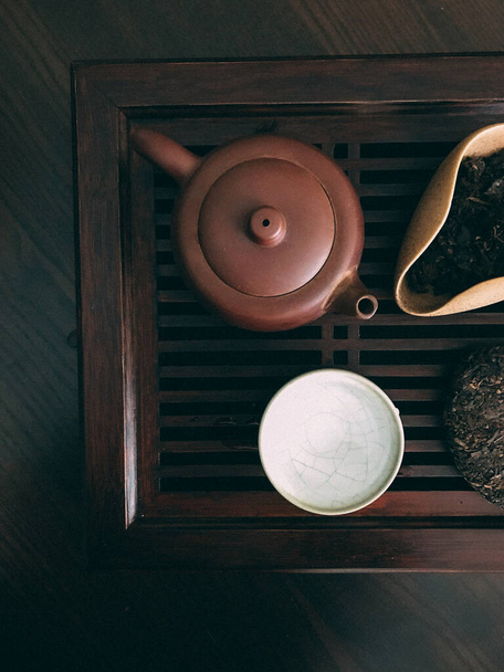 brewed tea, Chinese puer black tea, tea ceremony on a wooden board with beautiful dishes - Foto, immagini