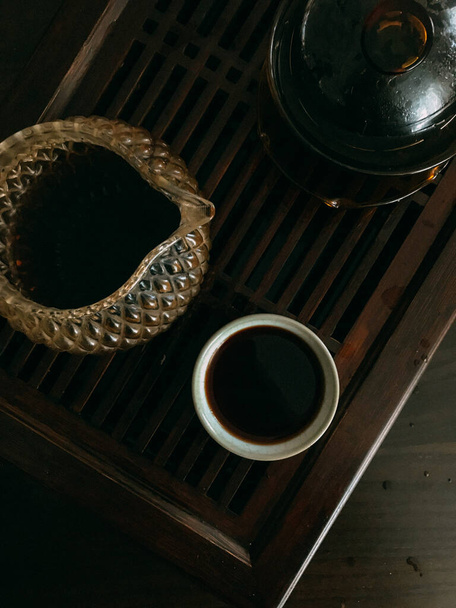 brewed tea, Chinese puer black tea, tea ceremony on a wooden board with beautiful dishes - Fotografie, Obrázek