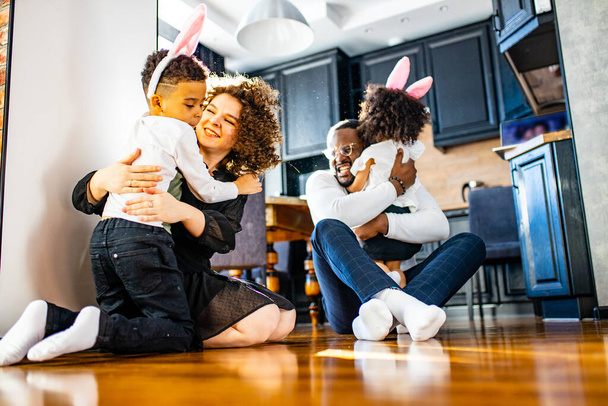 multicultural hispanic family wearing rabbit ears in living room soft sun day light - Photo, image