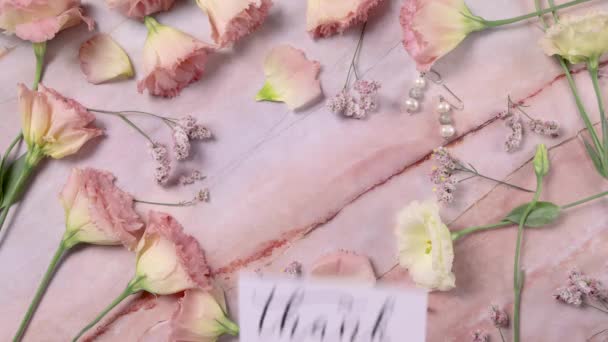 Carte MOTHERs DAY sur une table en marbre près de fleurs roses vue du dessus  - Séquence, vidéo