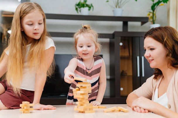 mom and daughters play blocks. educational and interesting games for family. - Fotoğraf, Görsel