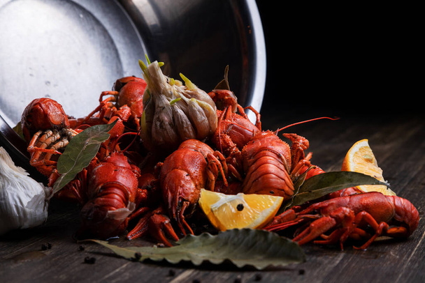 delicacy for beer, boiled red crayfish with lemon and bay leaves - Фото, зображення