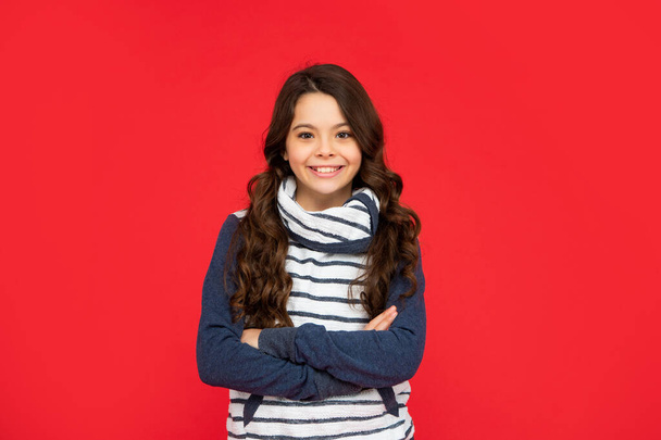 teen girl on red background. portrait of child wearing warm clothes. express positive emotion. - Foto, Imagen