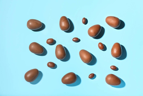 Delicious chocolate eggs on blue background - Photo, Image
