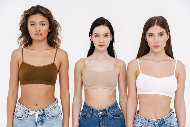 Young three women wearing bra posing and looking at camera isolated over white background - Φωτογραφία, εικόνα
