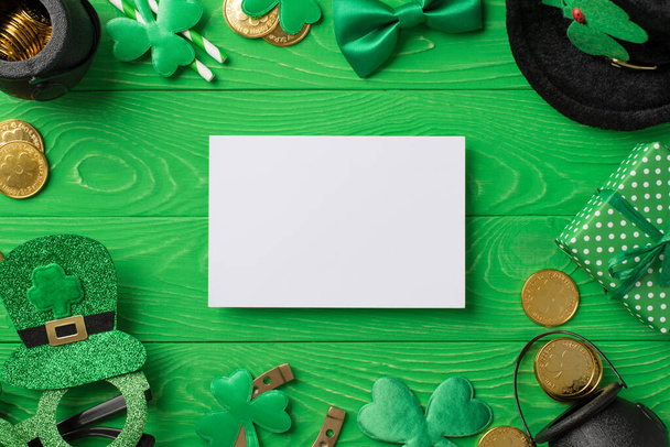 Top view photo of st patricks day decor paper sheet party glasses leprechaun hat straws bow-tie giftbox horseshoe shamrocks pots gold coins on isolated green wooden table background with copyspace - Fotó, kép