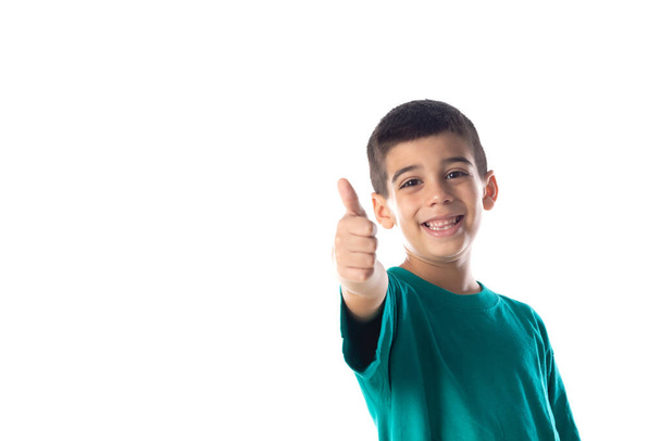 Funny child with green T-shirt saying Ok and isolated on a white background - Foto, Imagem