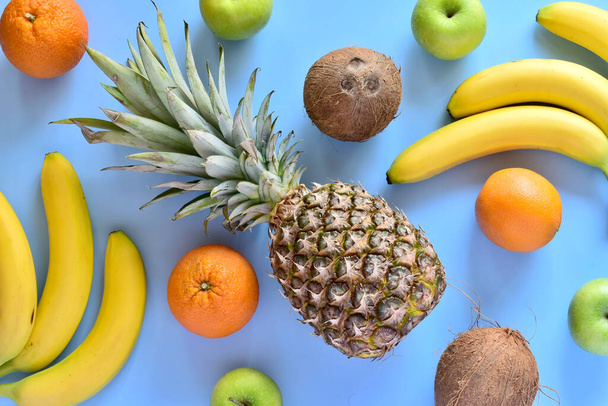fresh fruits and vegetables on a blue background. - Foto, Bild