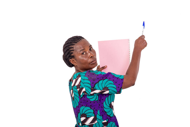 a female teacher in a loincloth dress standing on a white background giving a presentation on the blackboard. - Photo, Image