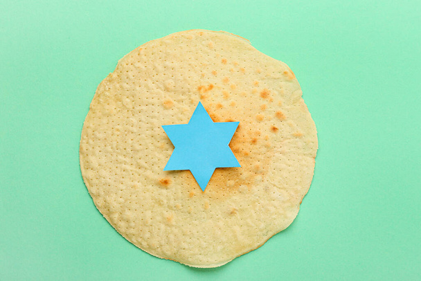 Еврейский лепешка маца на Пасху с бумагой Давида звезды на зеленом фоне - Фото, изображение