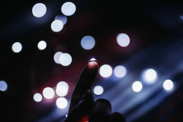 hand holding a glowing neon lights - Zdjęcie, obraz