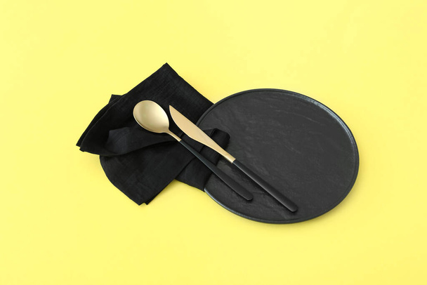 Simple table setting on yellow background - Foto, imagen
