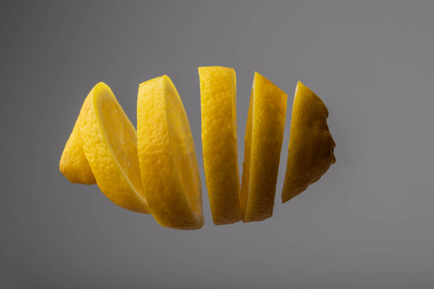 Sliced yellow lemon in space on a dark background. - Photo, image