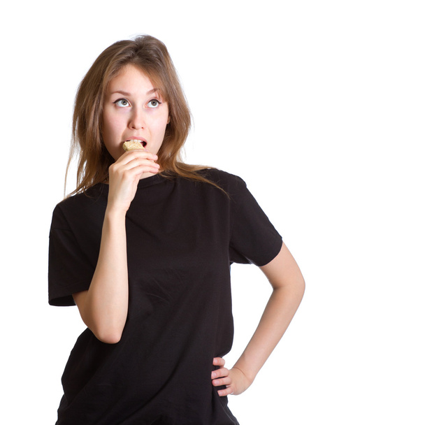 Thoughtful girl eating sesame brittle isolated - Fotoğraf, Görsel