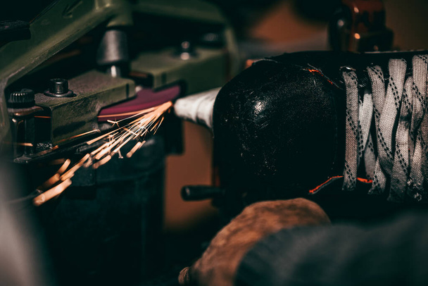 close up of a man's hand with a tattoo machine in a workshop - Fotó, kép