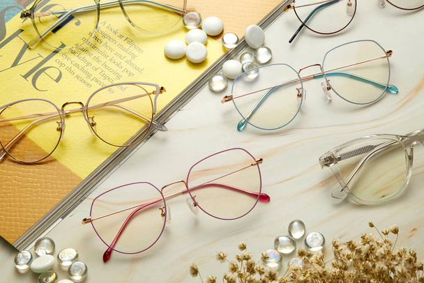 glasses with eyeglasses and stethoscope on wooden background - Fotografie, Obrázek