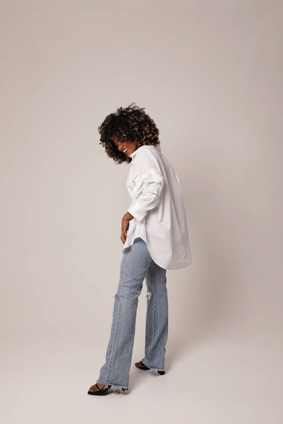Full length photo of beautiful young woman with curly hair posing on white. - Фото, изображение