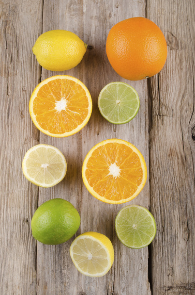 orange, lemon and lime on rustic wood - Photo, Image