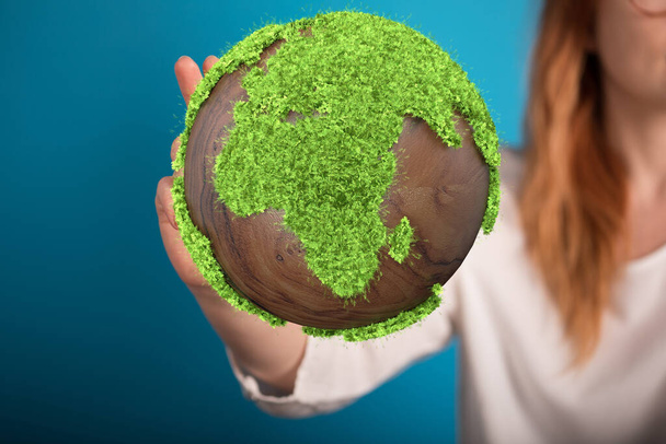 earth planet in hands of woman holding green globe on a background of blue sky - Foto, immagini