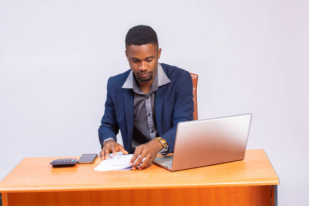 african american businessman sitting at the table and looking at the laptop - Photo, Image