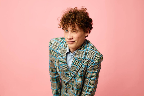 Young curly-haired man gesturing with his hands emotions checkered jacket Lifestyle unaltered - Photo, image