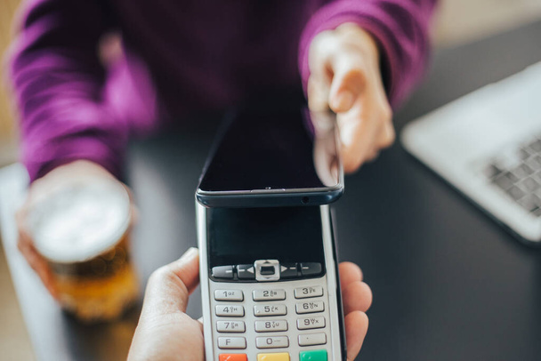 woman paying payment on smartphone with credit card and mobile phone - Foto, Imagen