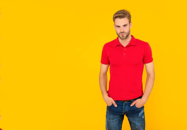 casual unshaven young man in red shirt on yellow background, mens beauty - Fotó, kép