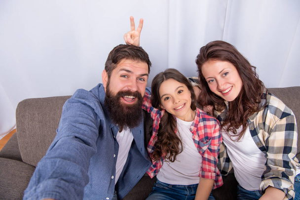 happy parents with kid at home. mom dad and daughter love relax together. - Fotó, kép
