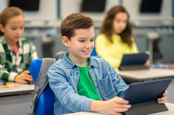Boy looking at tablet at school lesson - Foto, Imagem