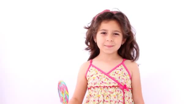 Little girl using a lollipop as a baton for cheerleader - Footage, Video