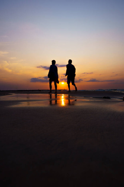 silhouette of a couple on the beach - 写真・画像