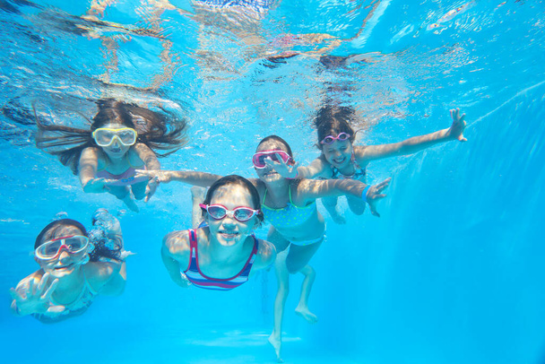 little happy  kids swimming  in pool  underwater. - Foto, Bild