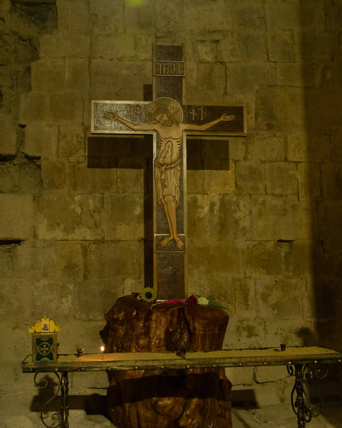 View of an ancient orthodox Crucifix in a dimly lit room in Georgia. - Photo, Image