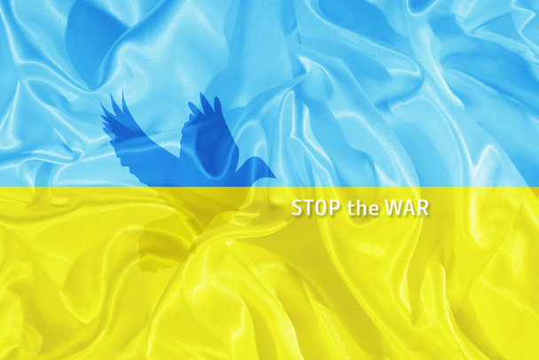 Állítsa meg a háborús szöveget a kék és sárga ukrán zászló a sziluett a galamb a béke. - Fotó, kép