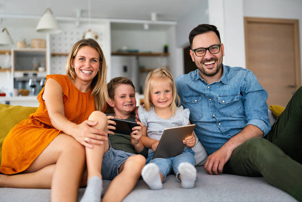 Digital device technology family online education concept. Happy young family with digital devices at home. - Valokuva, kuva