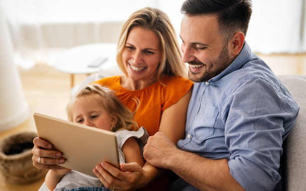 Happy family spending time at home and using digital device together. Technology people fun concept. - Fotoğraf, Görsel