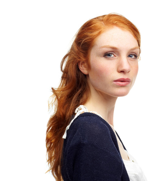 Pensive and fiery. Studio portrait of an attractive redhead isolated on white. - Фото, зображення