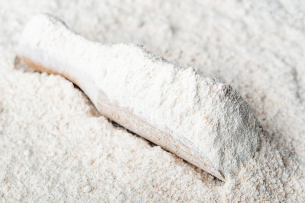 Whole grain flour in wooden scoop - Photo, image