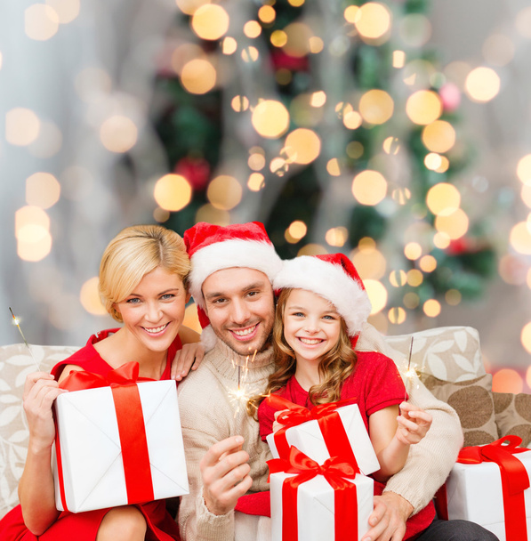 happy family in santa helper hats with gift boxes - Foto, Bild