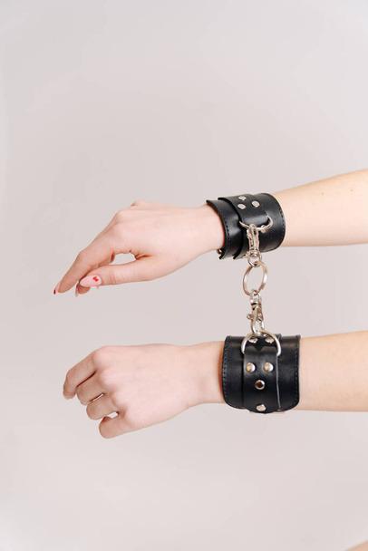 Pair of a black fetish leather handcuffs - Foto, imagen