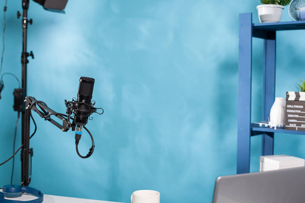 Сосредоточьтесь на профессиональном микрофоне поворотной стрелы руки стенд в пустой студию передачи подкастов - Фото, изображение