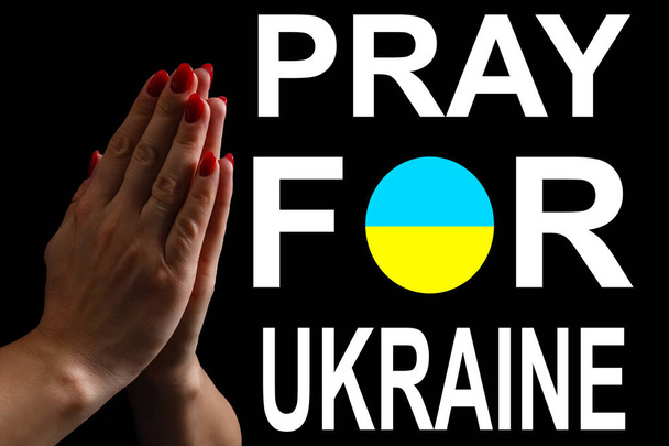 Pray for ukraine. hands pray on ukraine flag - Photo, Image
